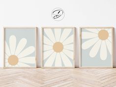 three framed art prints with daisies on them