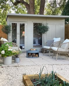 an outdoor living area with patio furniture and fire pit