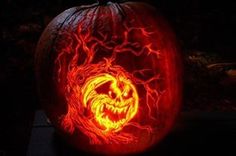 a carved pumpkin with an evil face on it's side and lightning coming out of its mouth