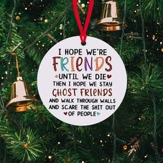 a christmas ornament hanging on a tree with two bells in front of it and the words, i hope we're friends until we die then hope we stay ghost