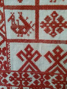 red and white cross - stitched fabric with different designs on it's edges