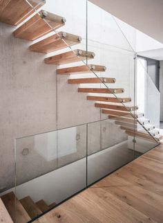 a wooden and glass staircase in a house