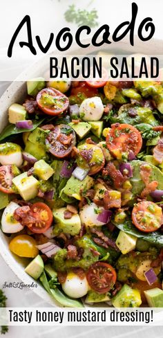 a salad with tomatoes, avocado and bacon is shown in a white bowl