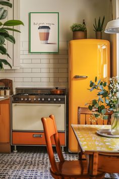 a kitchen with an orange refrigerator, yellow stove and wooden dining table in front of it