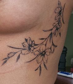 a woman's chest with flowers on it and the bottom part of her stomach