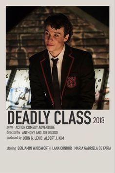 a man in a suit and tie standing next to a brick wall with the words deadly class on it