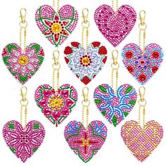 six heart shaped beaded keychais hanging from chains with different colors and designs