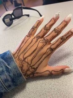 a person's hand with tattoos on it