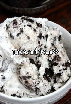 cookies and cream ice cream in a bowl on a table with the words cookies and cream above it