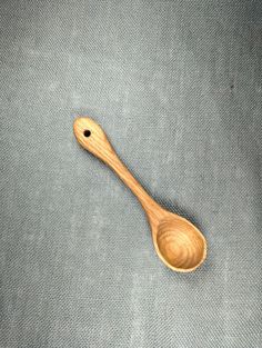 a wooden spoon sitting on top of a gray cloth