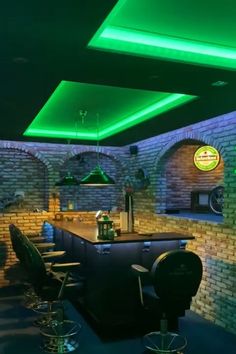 a bar with several stools and lights on the ceiling, in front of a brick wall