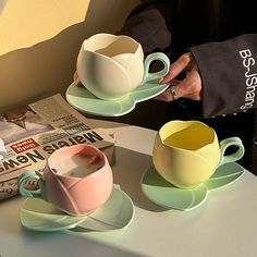 two coffee cups and saucers on a table