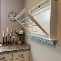 a kitchen counter with utensils hanging on the wall