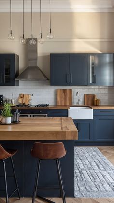 a kitchen with blue cabinets and wooden counter tops