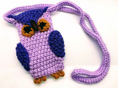 a crocheted owl purse is shown on a white surface with a purple strap