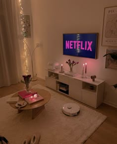 a living room filled with furniture and a flat screen tv mounted to the side of a wall