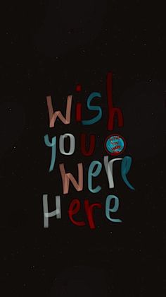 the words wish you were here are written in multicolored letters on a black background