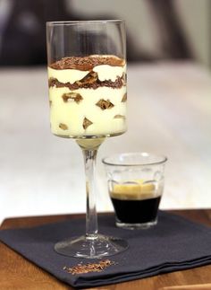 a dessert in a wine glass on a table