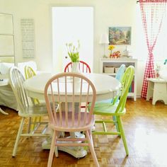 a dining room filled with lots of furniture next to a white table and chair set