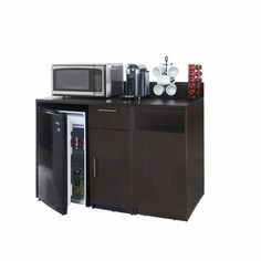 an open refrigerator and microwave combination unit