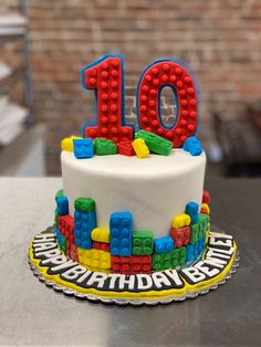 a birthday cake decorated with legos and the number ten