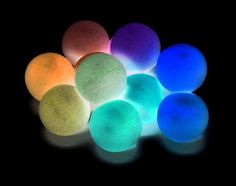 glow in the dark balls on a black background