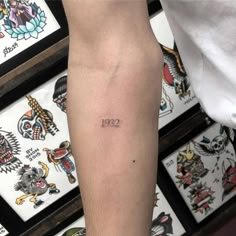 a person with a small tattoo on their left arm and the word 1932 written in it