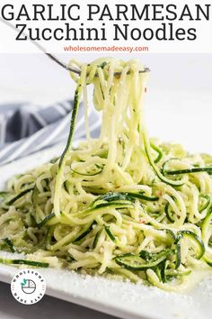 garlic parmesan zucchini noodles on a white plate with text overlay