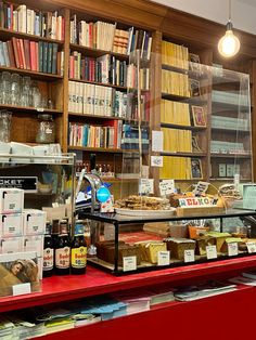 a store filled with lots of books next to a shelf full of boxes and other items