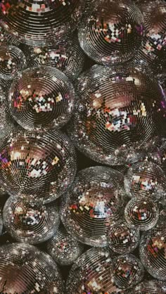 many disco balls are stacked on top of each other in the middle of an image