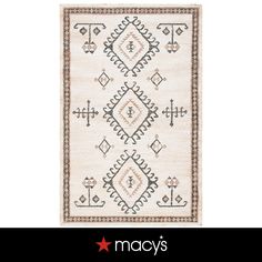 a white rug with an intricate design on the front and side, in different colors