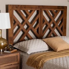 a bed with a wooden headboard and pillows