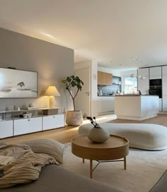 a living room filled with furniture next to a kitchen