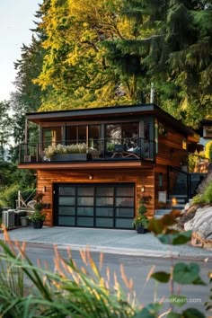 a large wooden house sitting on top of a lush green hillside next to tall trees