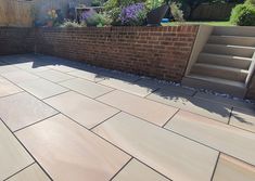 an outdoor patio with stone steps and brick walls