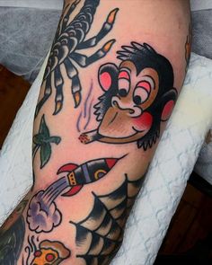 a man with tattoos on his arm holding a knife