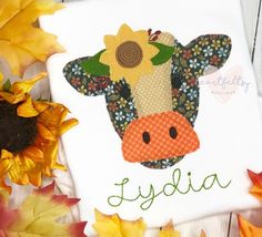 a cow with sunflowers and name on it