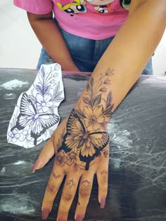 a woman's hand with tattoos on it