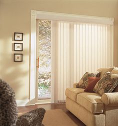 a living room filled with furniture and a sliding glass door