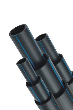 four black plastic pipes stacked on top of each other in front of a blue circle