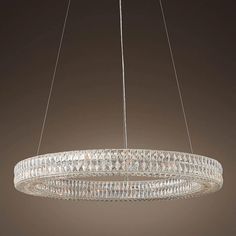 a round chandelier hanging from a ceiling fixture with crystal beads in the center