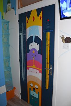 a door decorated to look like cartoon characters with a ruler and crown on the front