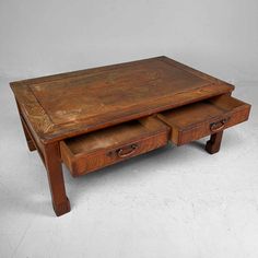 a wooden coffee table with two drawers on each side and an open drawer underneath it