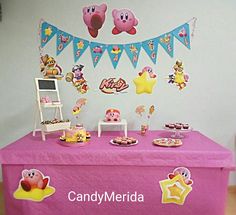 there is a candy themed table with decorations on it