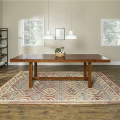 a wooden table sitting on top of a rug