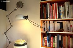 a lamp that is sitting on top of a book shelf next to a bookshelf