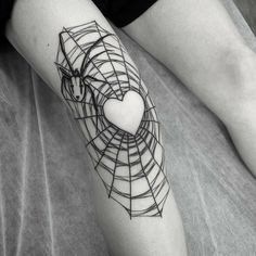 a woman's leg with a heart and lines tattoo on the side of her leg