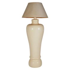 a white table lamp with a beige shade on the base and a light bulb at the top