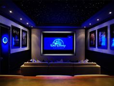 a home theater with blue lights and couches