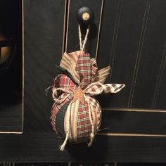 a doorknob with a bow hanging from it's side on a black wall